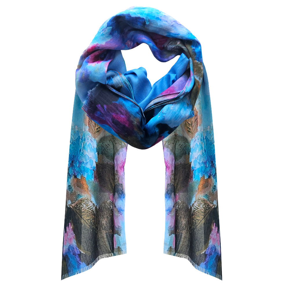 A blue and purple coloured cotton scarf with hydrangeas printed on. A soft moody design.