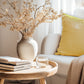 A bright gold velvet cushion with a plain design.