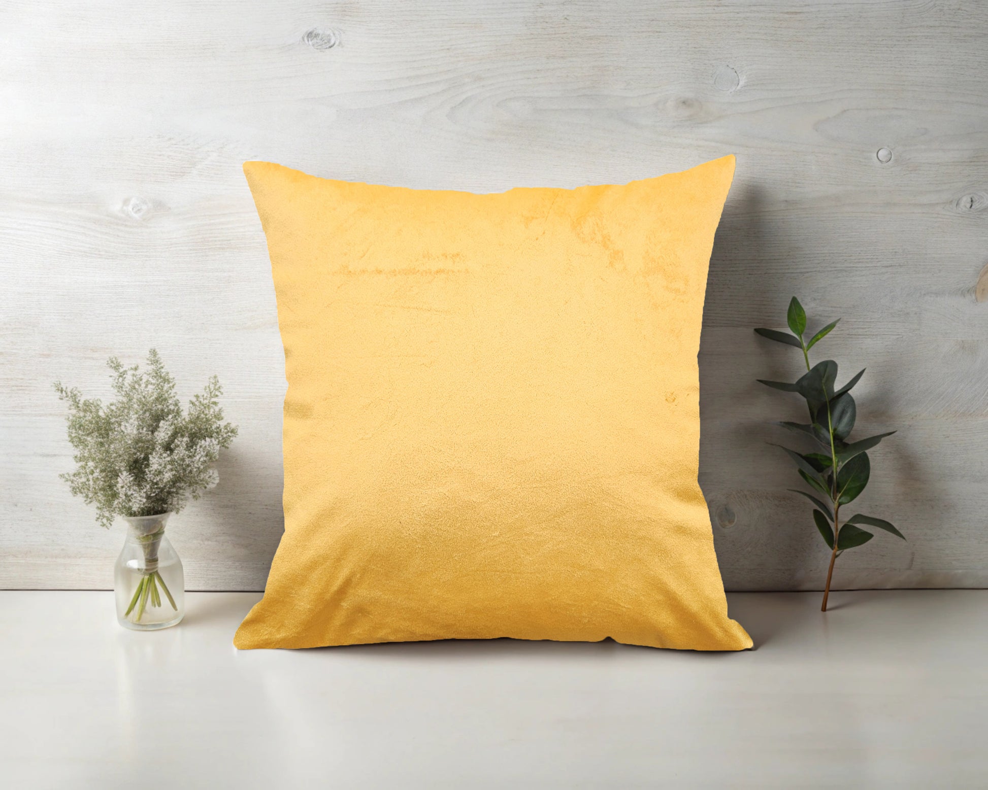 A bright gold velvet cushion with a plain design.
