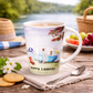 Mug with 'Happy Campers' design on a table with a scenic background