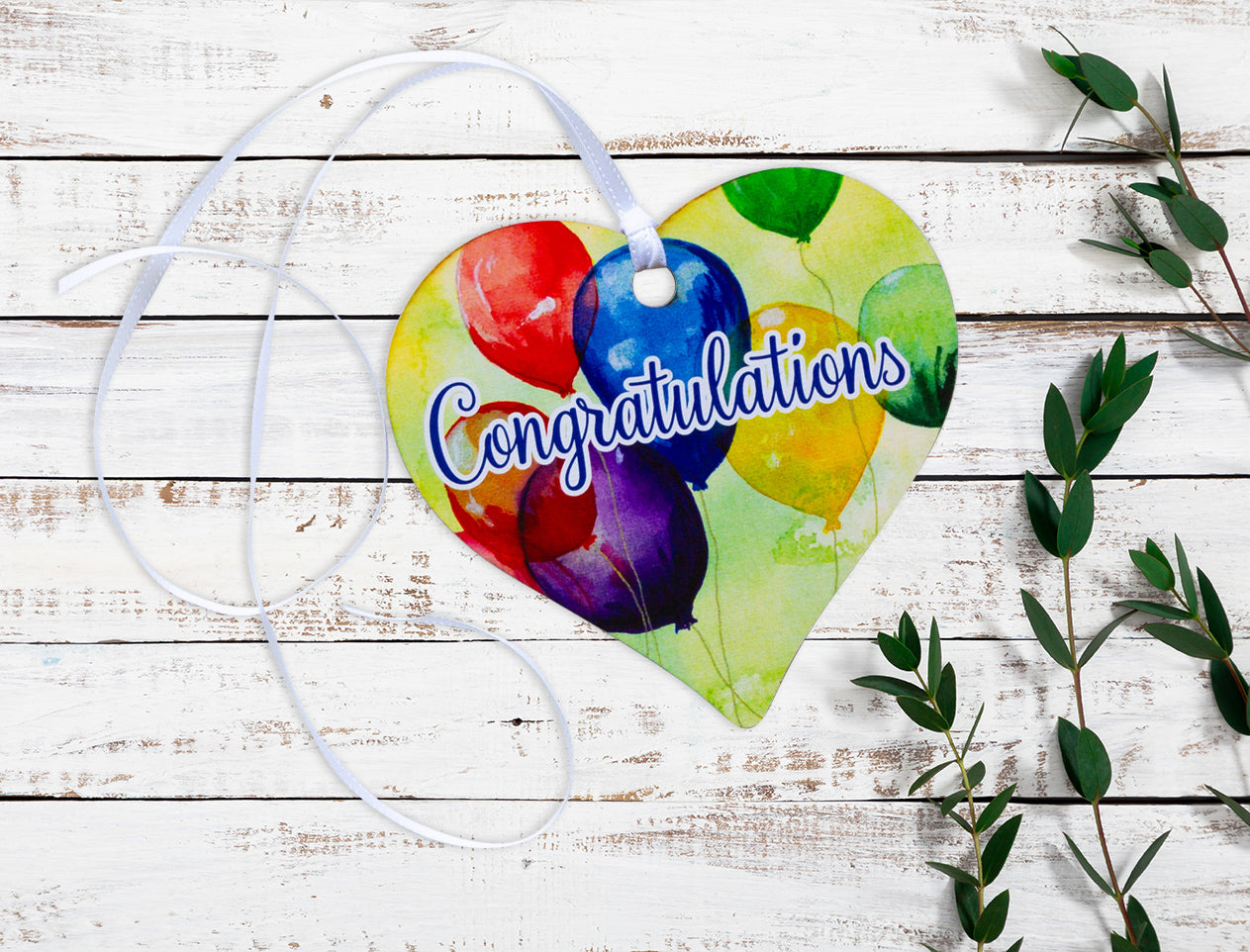 A wooden Keepsake Heart Tag with a balloon design and Congratulations written across the middle.