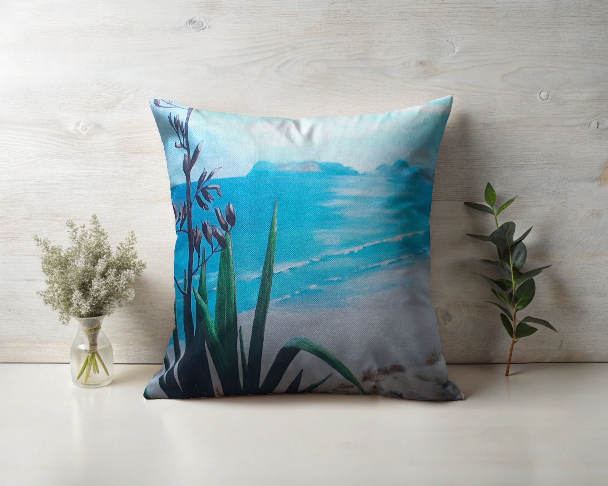 A New Zealand Flax plant by the beach linen cushion.