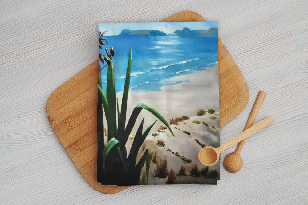 A Flax plant by the beach printed cotton tea towel. Beautiful beach and ocean scene with the artwork taken from Christina Maassen Art.