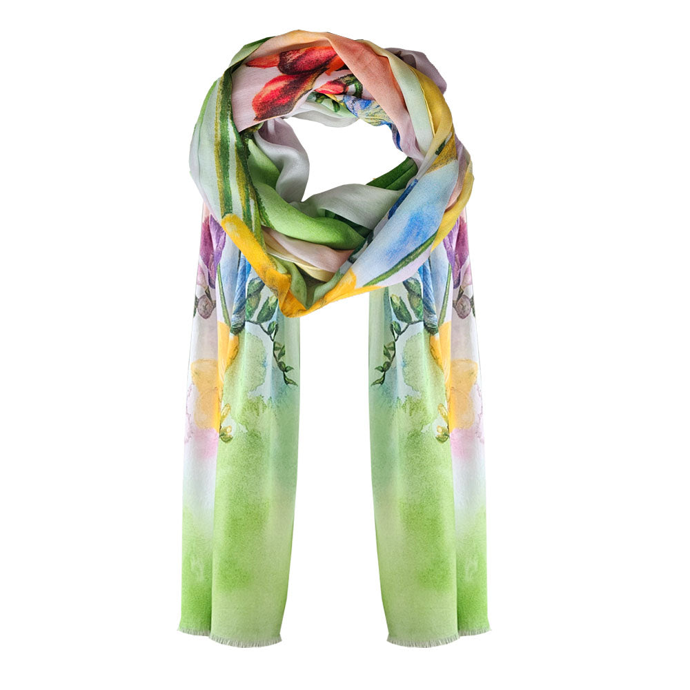 A floral scarf made from cotton with a multicoloured watercolour background and freesia flowers printed.