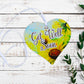A wooden heart gift tag with a daisy illustration and get well soon message written on across the middle.