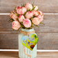 A wooden heart gift tag with a daisy illustration and get well soon message written on across the middle.