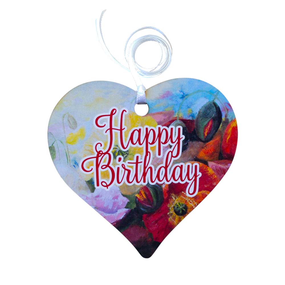 A wooden heart tag with a happy birthday message and floral design.