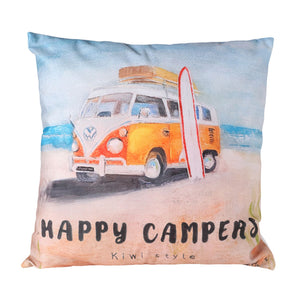 Decorative pillow with a camper van and surfboard design, featuring the text 'Happy Campers Kiwi style'.