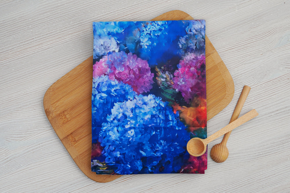 A beautiful cotton tea towel with a floral Hydrangea print. shades of blue and purple colours.