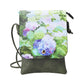 Crossbody bag with  Hydrangea floral design on top and green base.