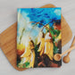 Kowhai floral print cotton tea towel with blue and yellow colours. Print taken from the original artworks of Christina Maassen Art.