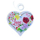 A wooden heart tag with the word love and a floral design.