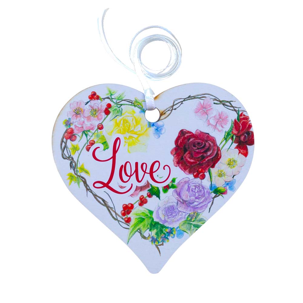 A wooden heart tag with the word love and a floral design.