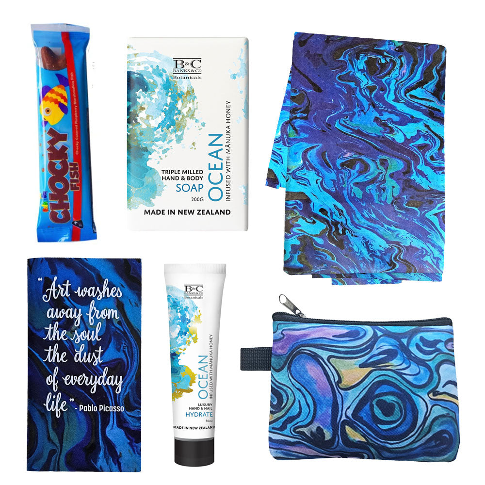 Cool Blue Ocean Gift Box featuring a paua art tea towel, coin purse, notebook, Banks & Co hand cream and soap and a chocolate fish, beautifully arranged in a gift box.