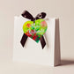 A wooden heart tag  saying Meri Kirihhimete, a kiwi christmas gift tag.