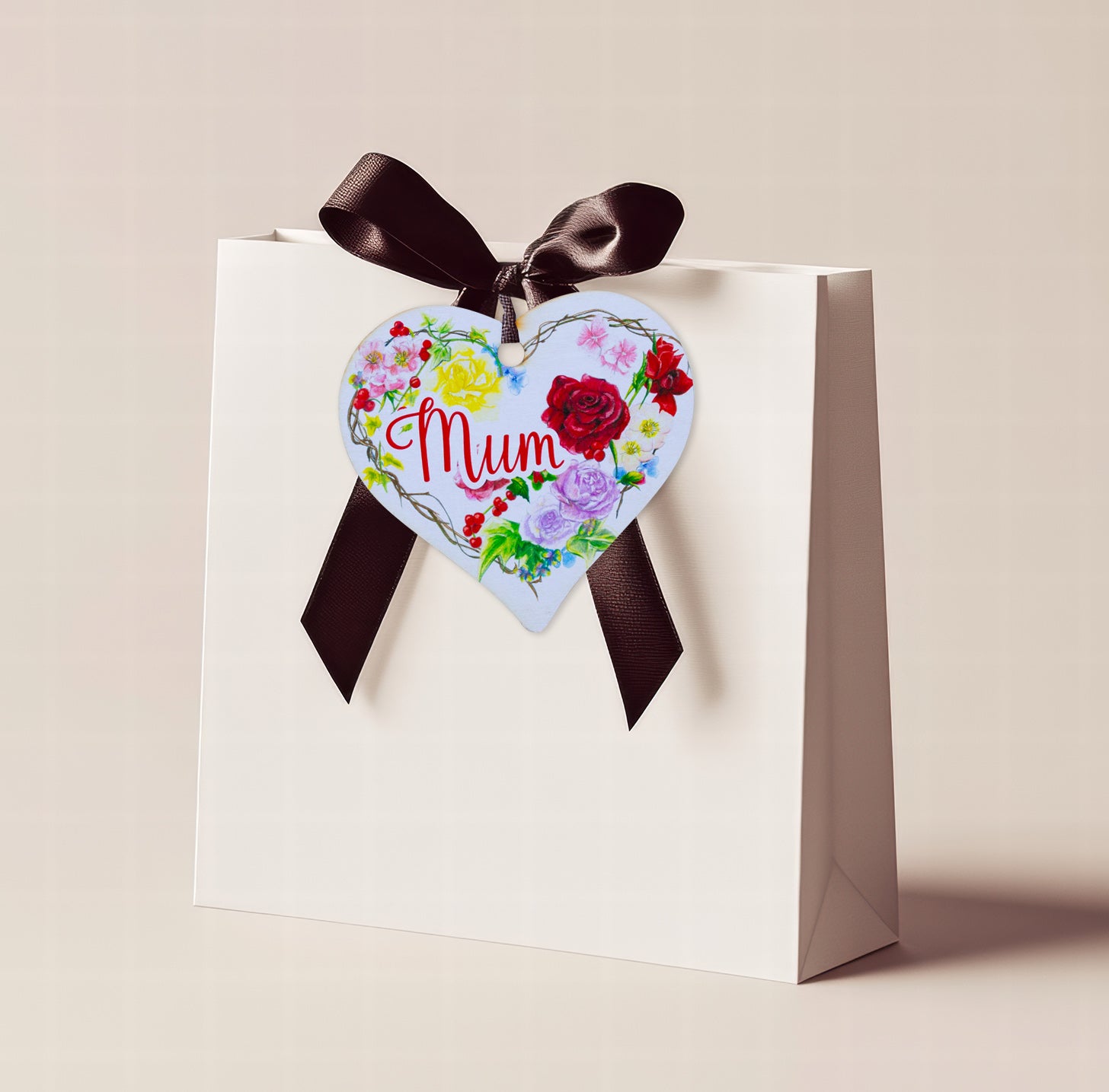A wooden heart tag with the message 'Mum' and a floral wreath design.