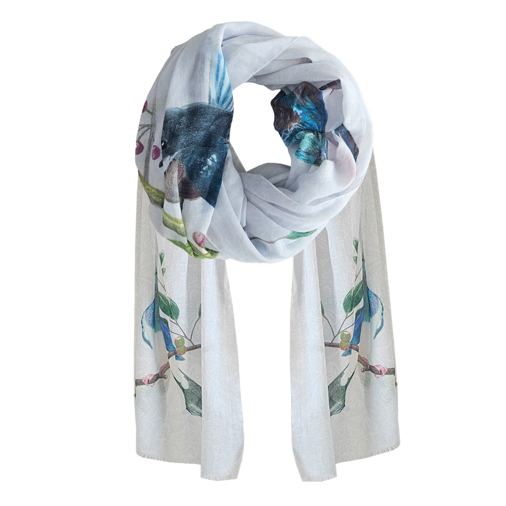 A white cotton Scarf with native New Zealand birds printed.