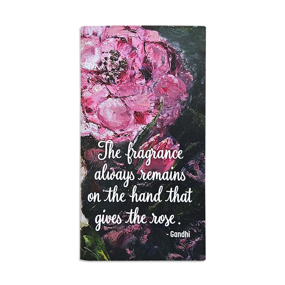 A pocket size notebook featuring a painted rose design 
