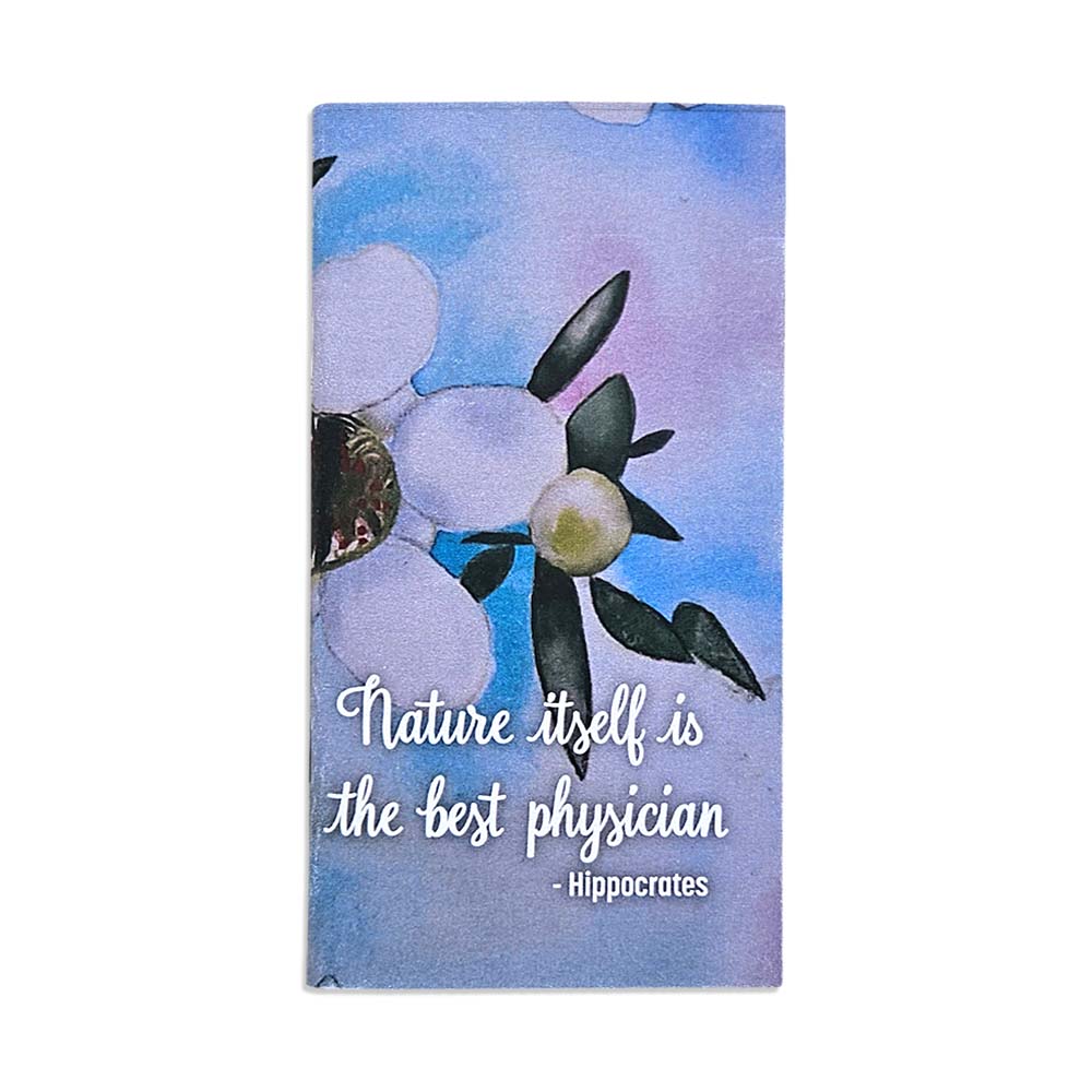 A pocket sized notebook with a white manuka flower design. 