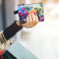 A fabric coin purse with a colourful pansy design all over. 