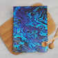 Featuring a stunning, high-quality print of vibrant abstract paua pattern in blue, this tea towel is both practical and beautiful.