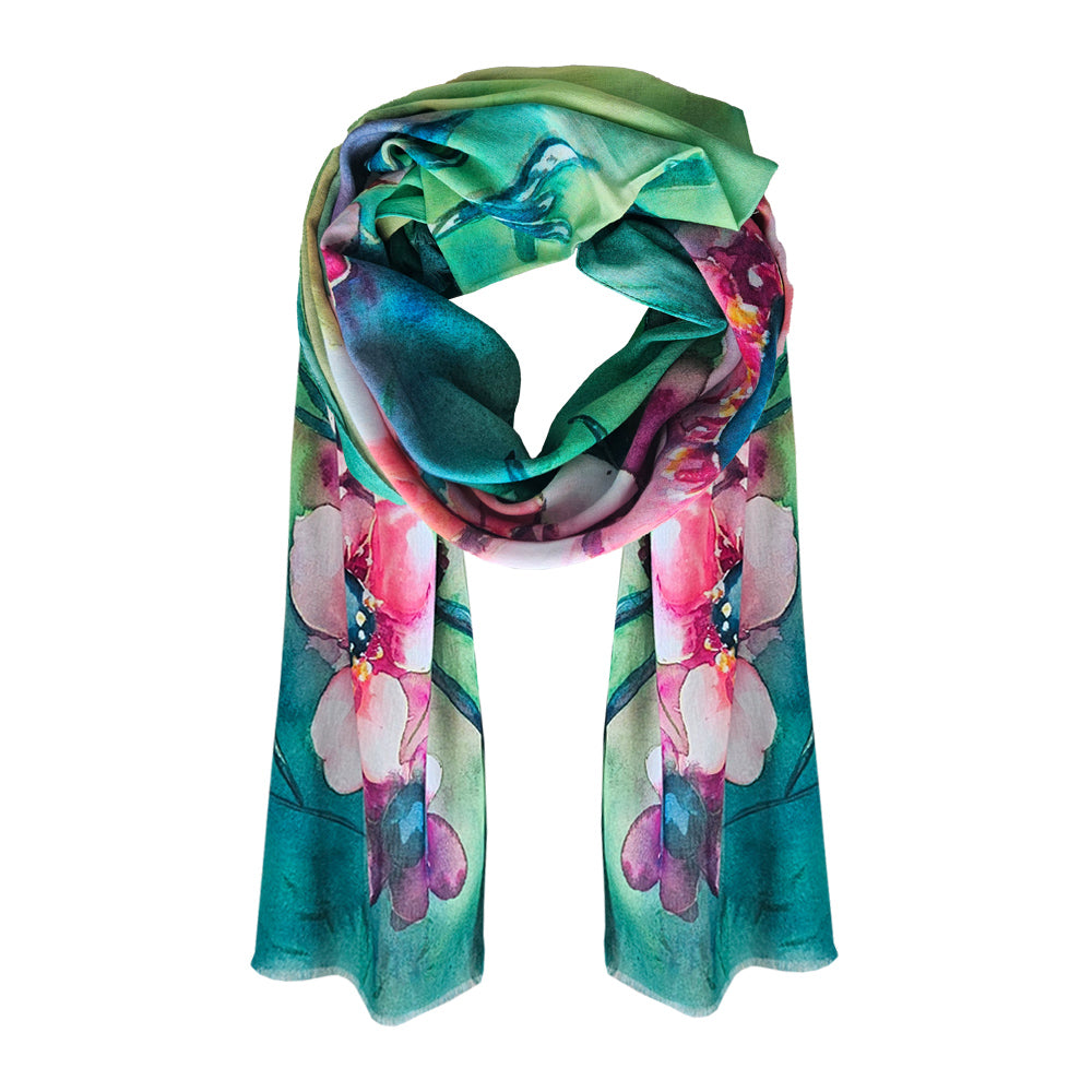 A green and pick coloured cotton scarf with manuka flowers printed throughout.