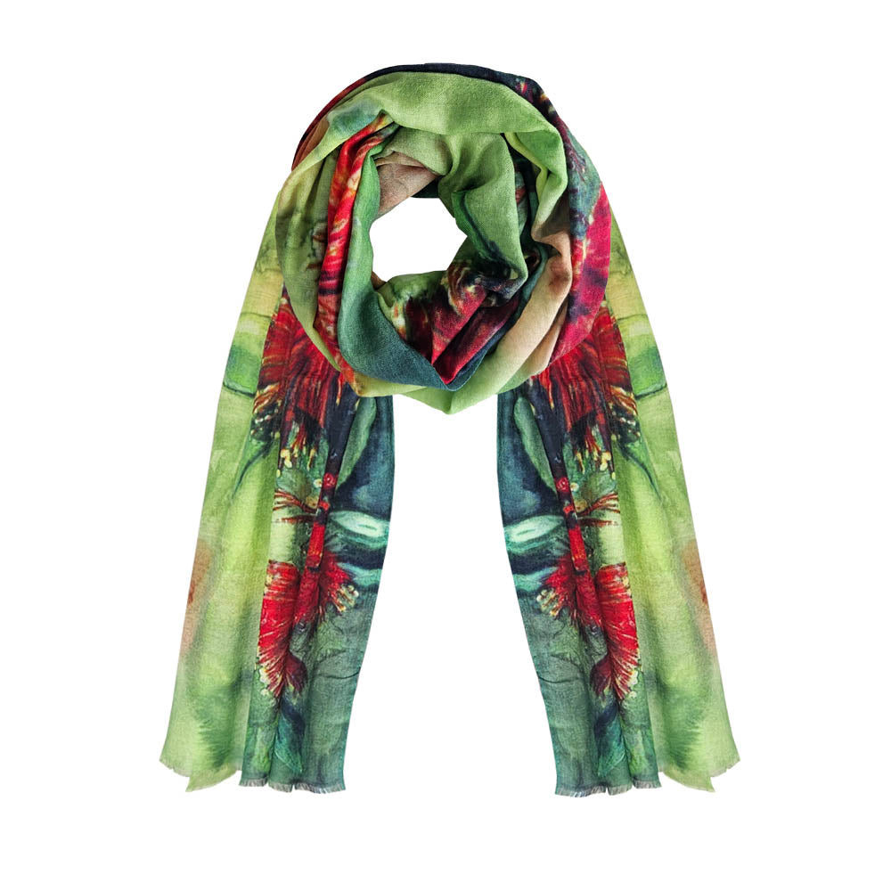 A pohutukawa printed scarf with red pohutukawa flowers on a green background.