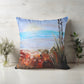 Decorative pillow with a nature-themed design on a wooden surface.