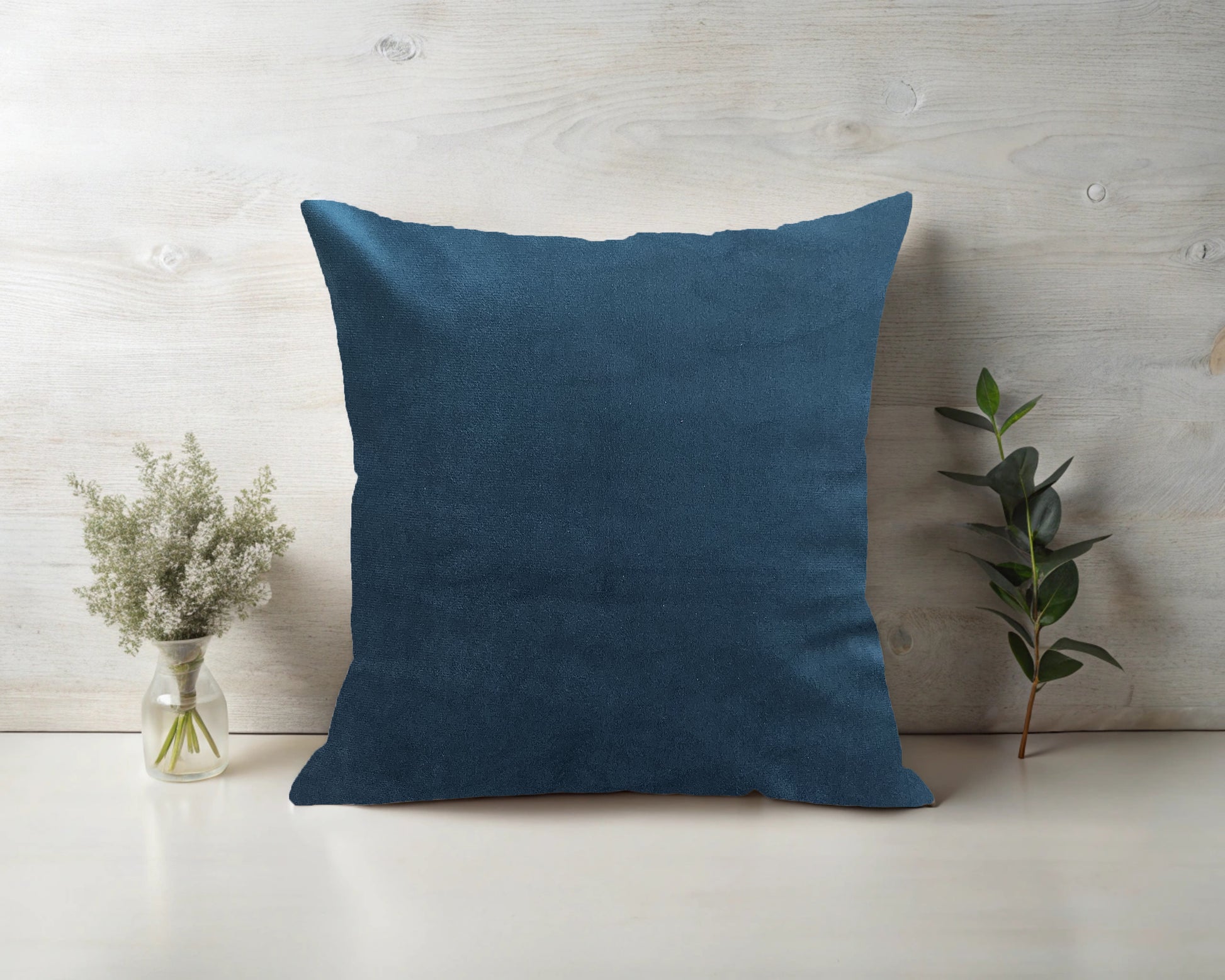 A teal coloured Satin cushion with inner.