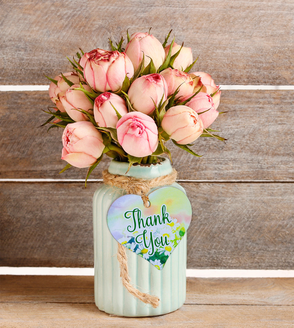 A wooden heart gift tag with a floral design taken from original artworks and the words thank you written across the front.