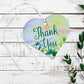 A wooden heart gift tag with a floral design taken from original artworks and the words thank you written across the front.