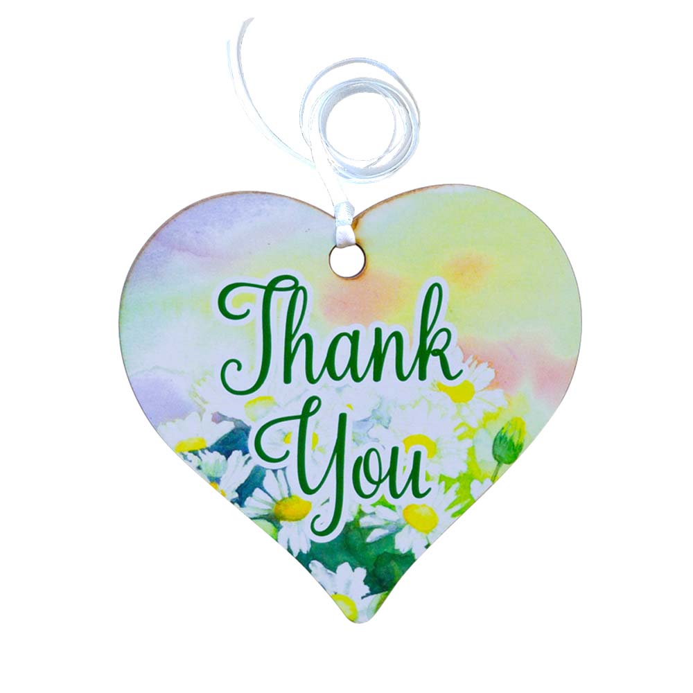 A wooden heart gift tag with a floral design taken from original artworks and the words thank you written across the front.