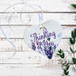 A wooden heart tag with thinking of you written, featuring  lavender flowers.