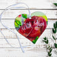 A wooden heart tag with the message 'with love' and a red rose design.