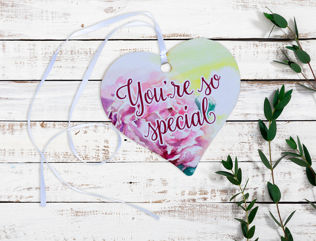 A wooden heart gift tag with a pink rose design and the message you're so special.
