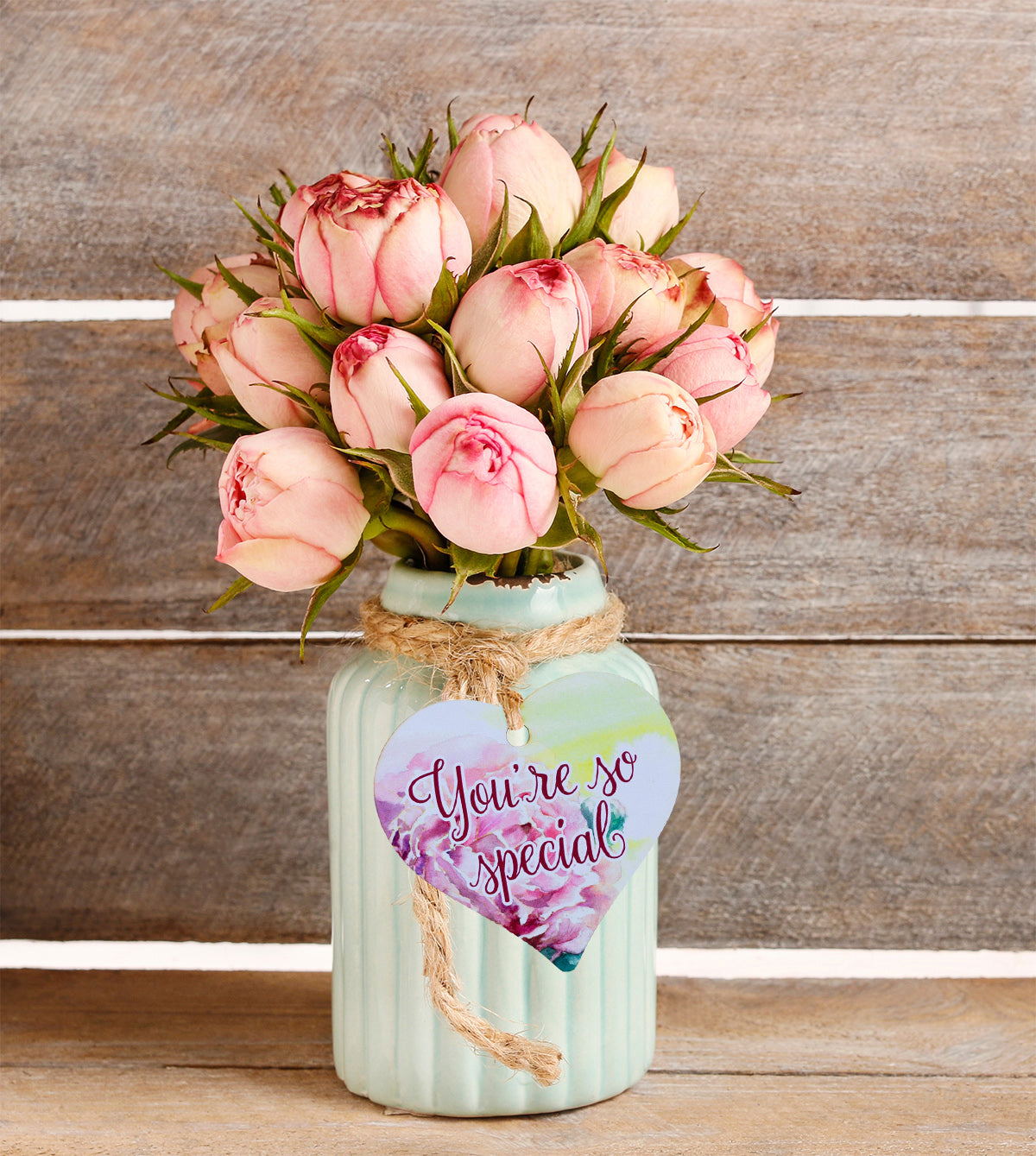 A wooden heart gift tag with a pink rose design and the message you're so special.